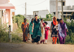 Ana walking through the Bhalupali village with her close-knit team. Image credits: Holi Boli