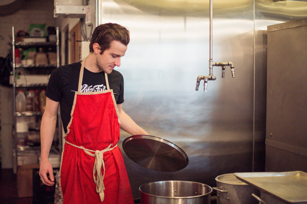 chef making bone broth with in large pot