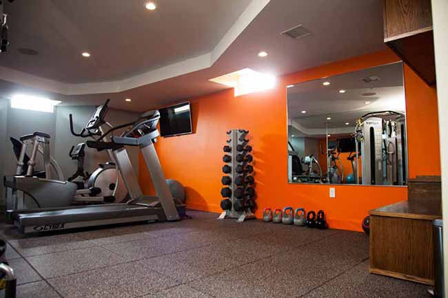 Home gym with orange walls