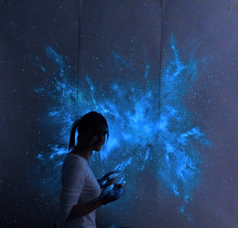 Esther Iranyi glow in the dark artist with glowing blue nebula wall mural