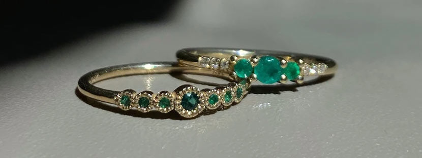 Two Jennie Kwon emerald rings shot in shadow 