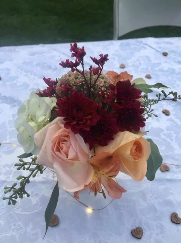 Wood hearts scattered around flower arrangement table decor