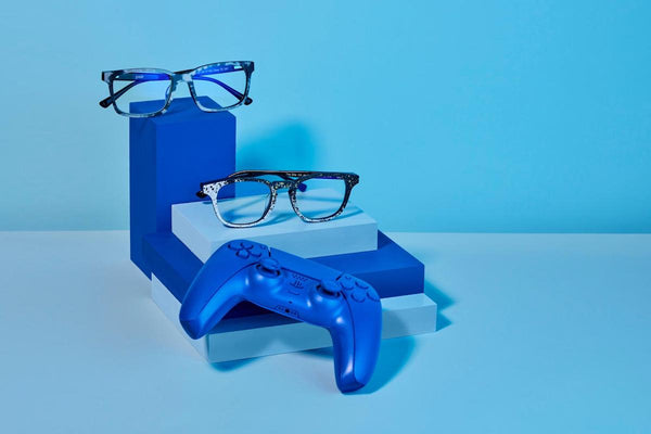 2 pairs of eyeglasses and a video game controller