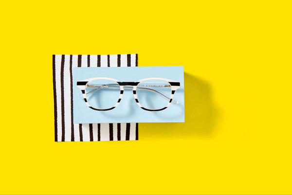 How do progressive lenses work: black and white eyeglasses on a yellow background