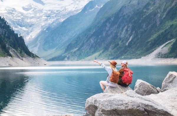 Depth perception: couple sitting on a rock by a lake