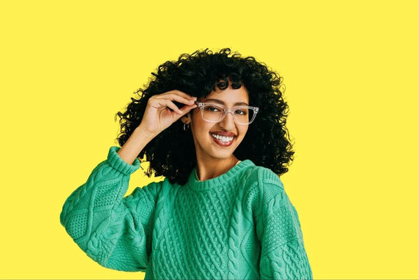 Geometric glasses: curly-haired woman wearing a pair of eyeglasses