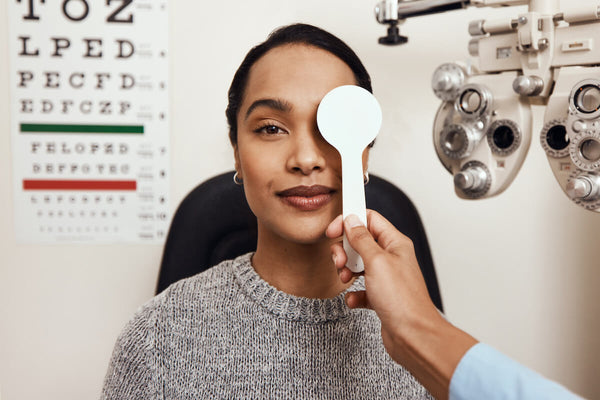 Doctor covering an eye of a patient