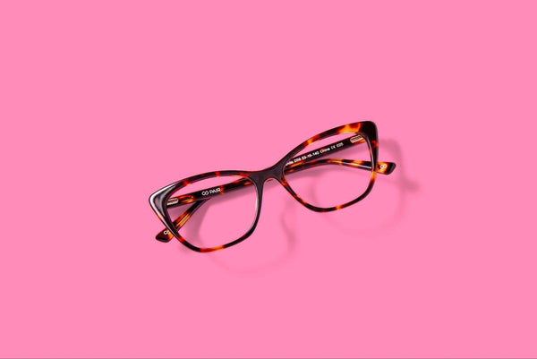 What are progressive lenses: brown eyeglasses on a pink background