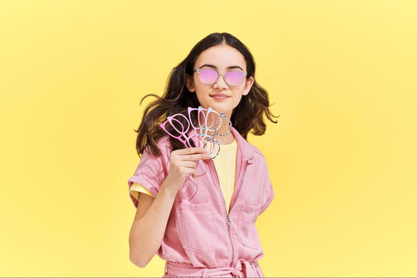 Girl holding 6 pairs of eyeglasses