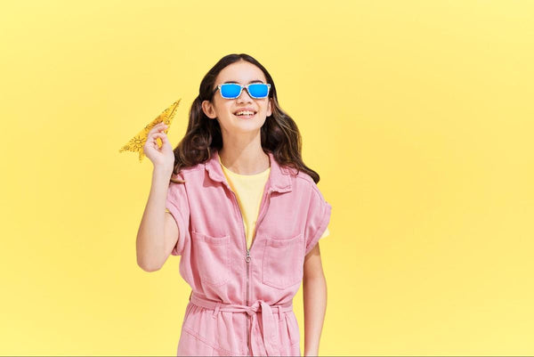 Girl holding a paper airplane