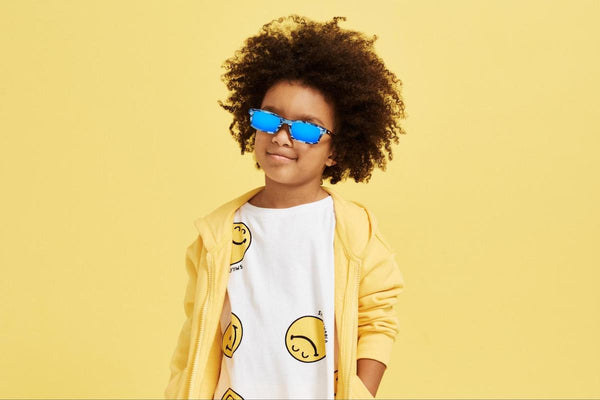 Summer eyeglasses: kid wearing The Classic Camo Sun Top sunglasses