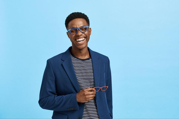 Man happily holding a pair of eyeglasses