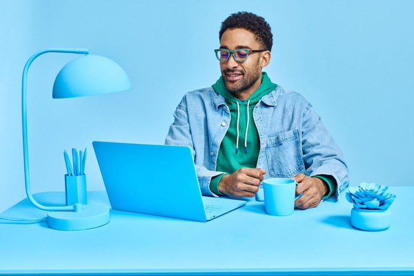 Glasses for light sensitivity: man looking at his blue laptop