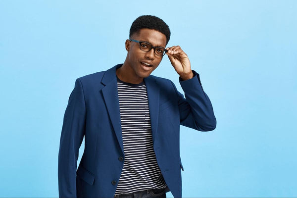 Sexy glasses: man wearing a blue blazer while posing at the camera