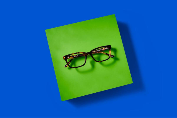 Oblong face glasses: pair of eyeglasses on a blue background