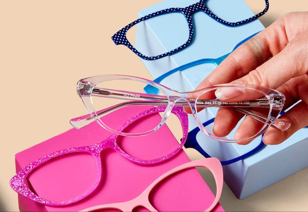 Person holding a pair of eyeglasses