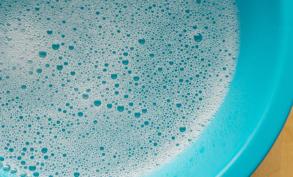 DIY eyeglass cleaner: soapy water in a blue bucket