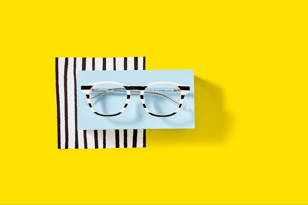 Striped eyeglasses on a yellow background