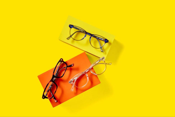 Three pairs of the best glasses for oval faces sitting on a yellow background.