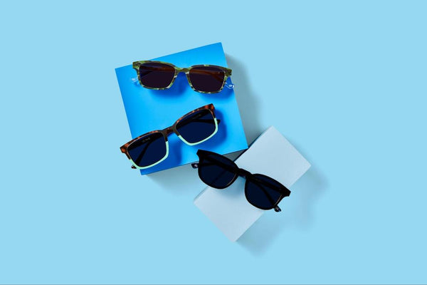 Polarized vs. non-polarized sunglasses: Three pairs of sunglasses sitting on a blue background