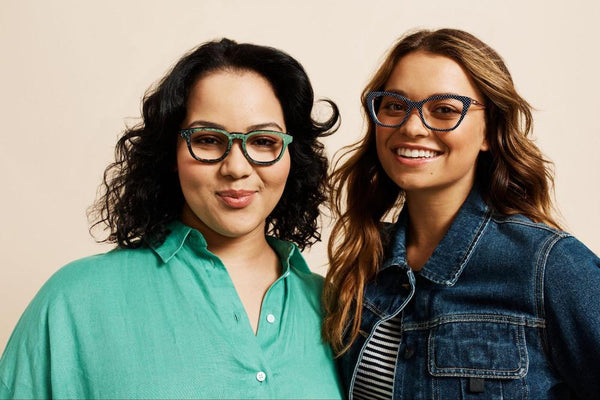 Two happy women wear colorful Pair Eyewear glasses vs. contacts.