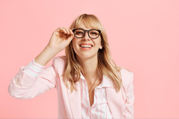 Woman happily wearing a pair of eyeglasses