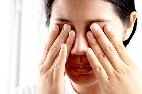 How do I know if I need glasses: Woman rubbing her eyes