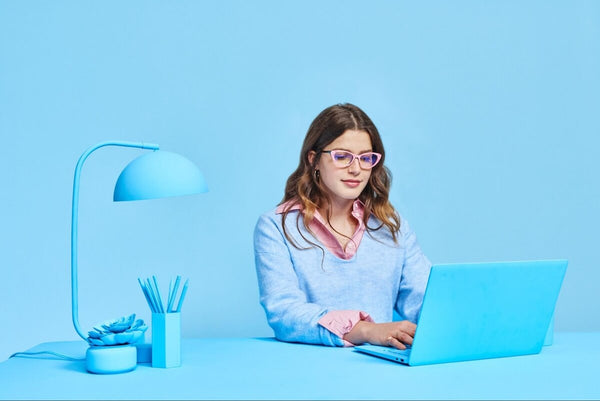 Woman using a blue laptop