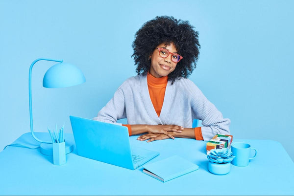 Woman wearing a pair of eyeglasses and smiling at the camera