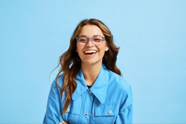 Woman wearing a pair of eyeglasses smiling at the camera