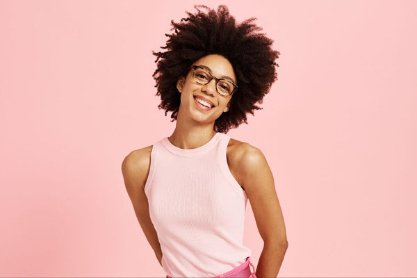 Circle glasses frames: woman wearing a pink top