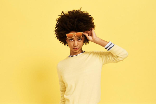 Different types of glasses: woman wearing a yellow sweater