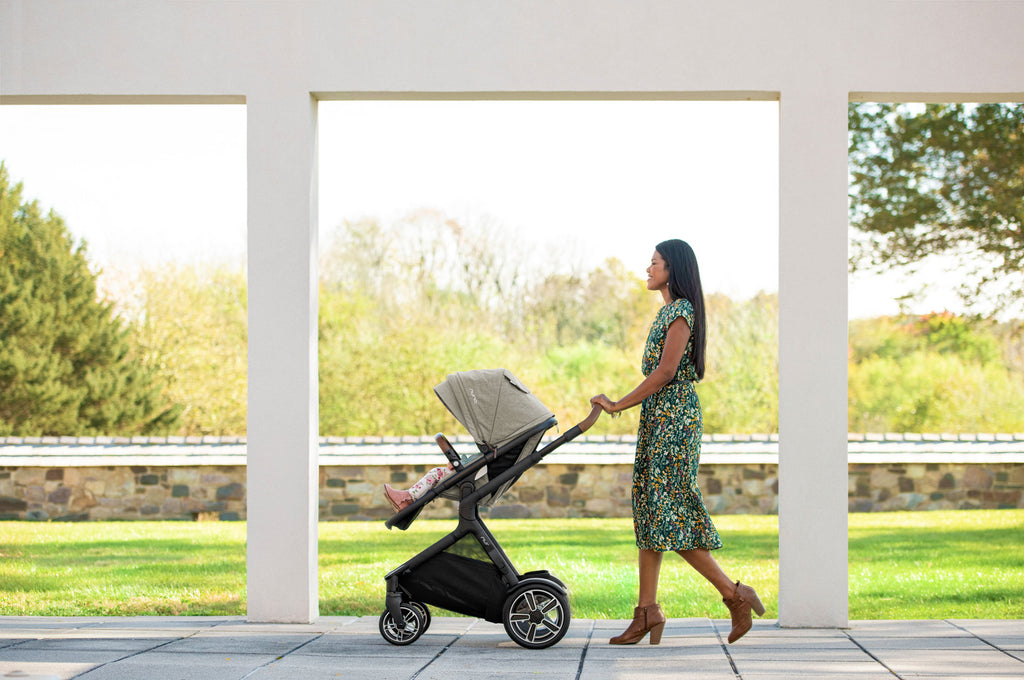 Stylish Mom Using A Nuna Demi Grow on A Beautiful Day