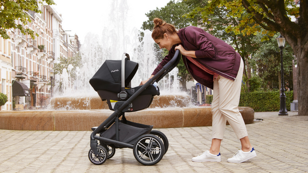Mother Checking on her Child in a Nuna Travel System
