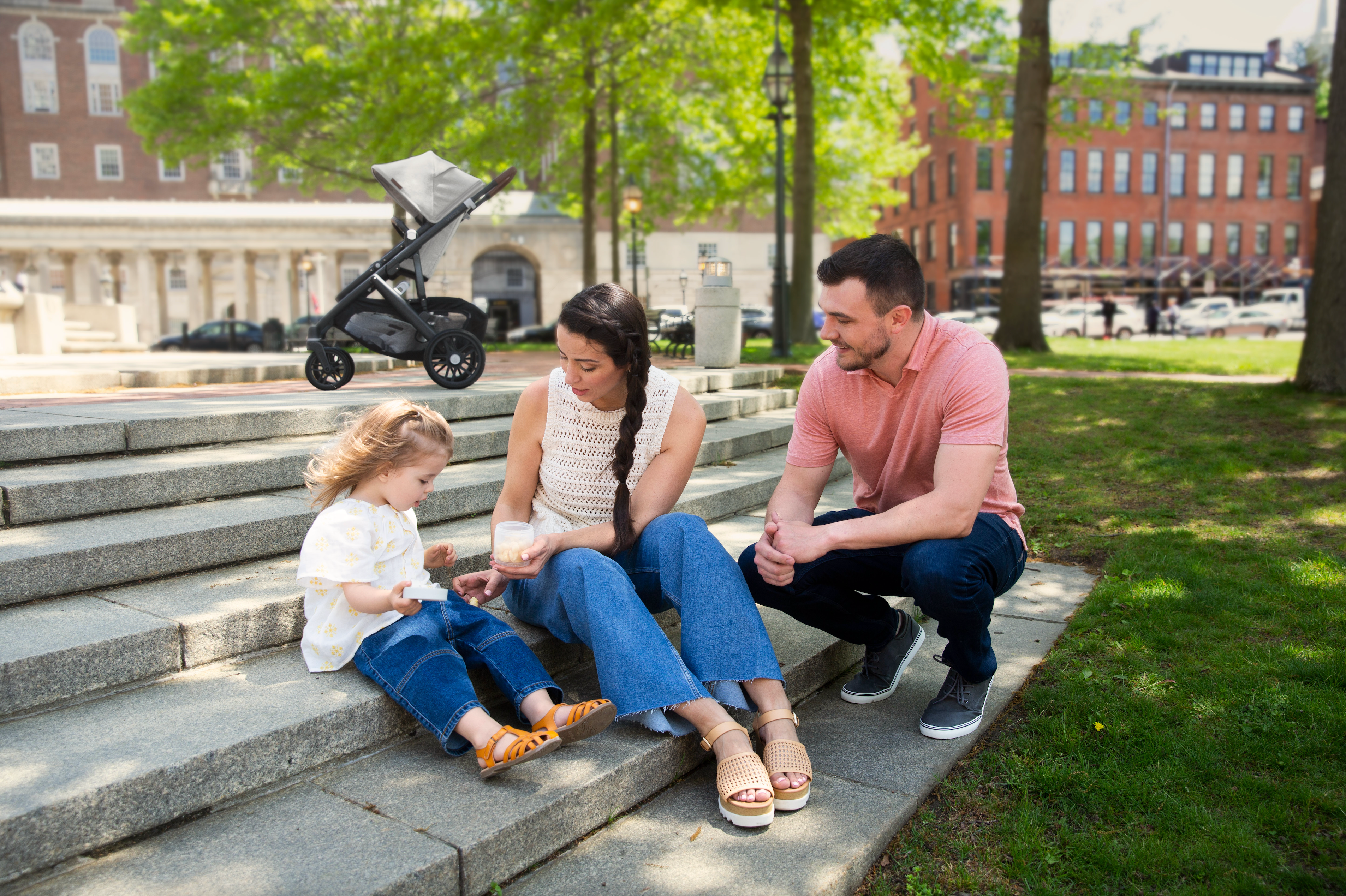 Parents and Their Daughter Enjoying A Stroll in the Park