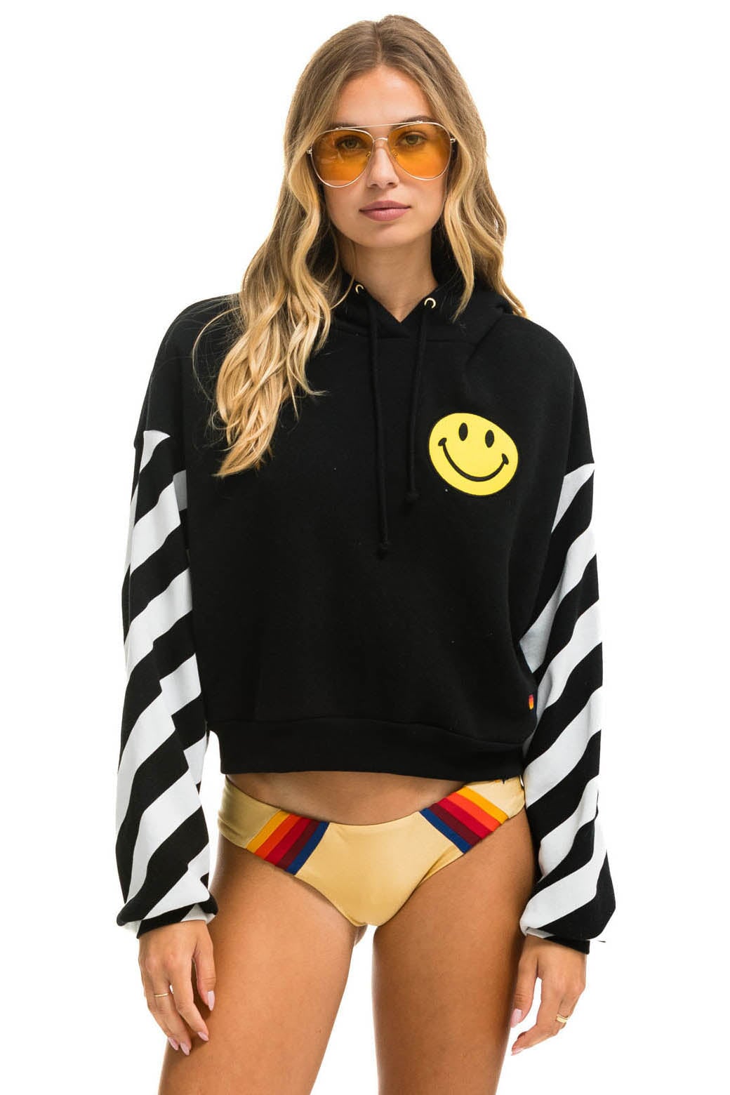 Image of CAUTION STRIPE SLEEVE SMILEY 2 EMBROIDERY RELAXED CROPPED PULLOVER HOODIE - BLACK // WHITE