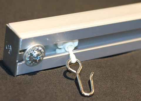 a ceiling track curtain rod with hooks