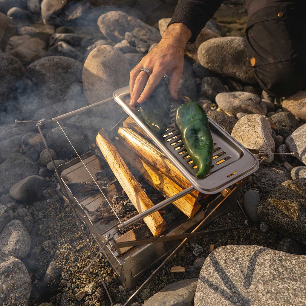 Roasting whole Poblano peppers on campfire grill