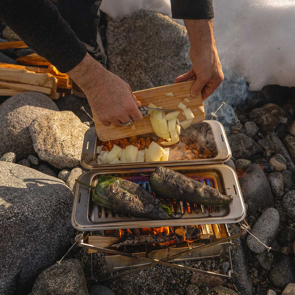 Cooking chorizo chili over campfire