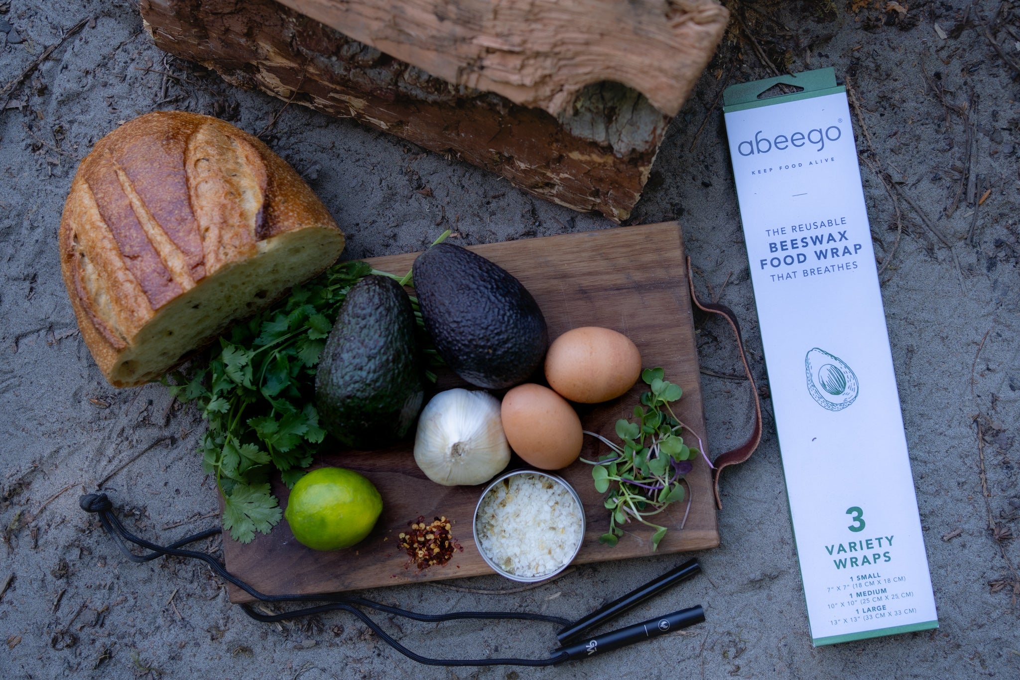 Produce on a cutting board with Wolf and Grizzly's Fire Set and Abeego Food Wraps