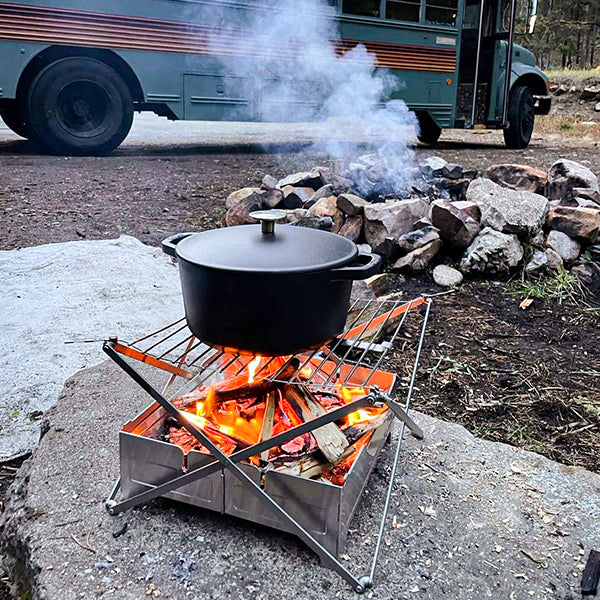 Camp cast-iron Dutch oven on top of campfire grill