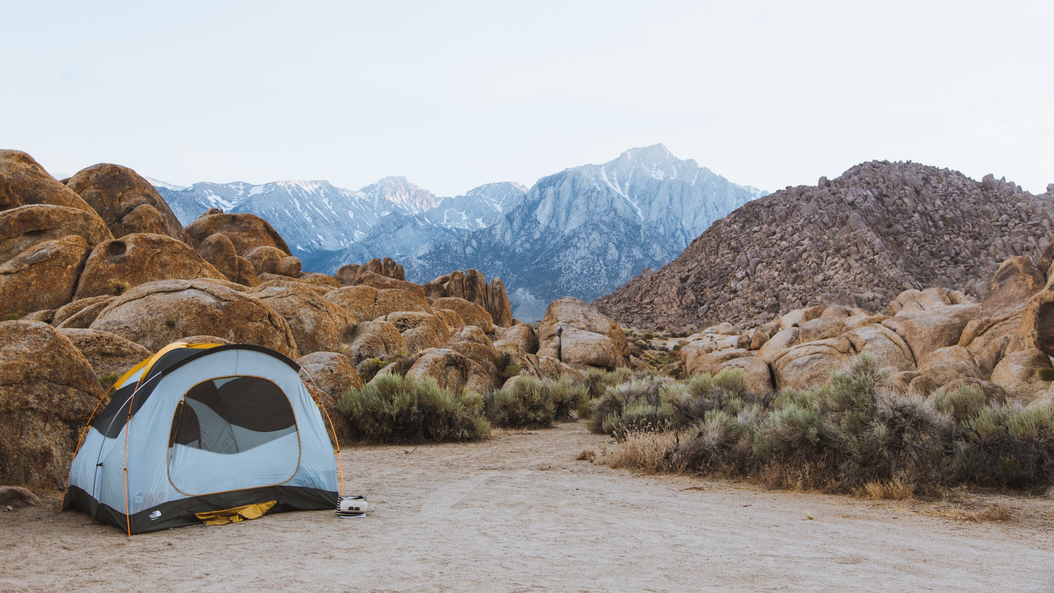 Tent camping in a sandy desert valley 