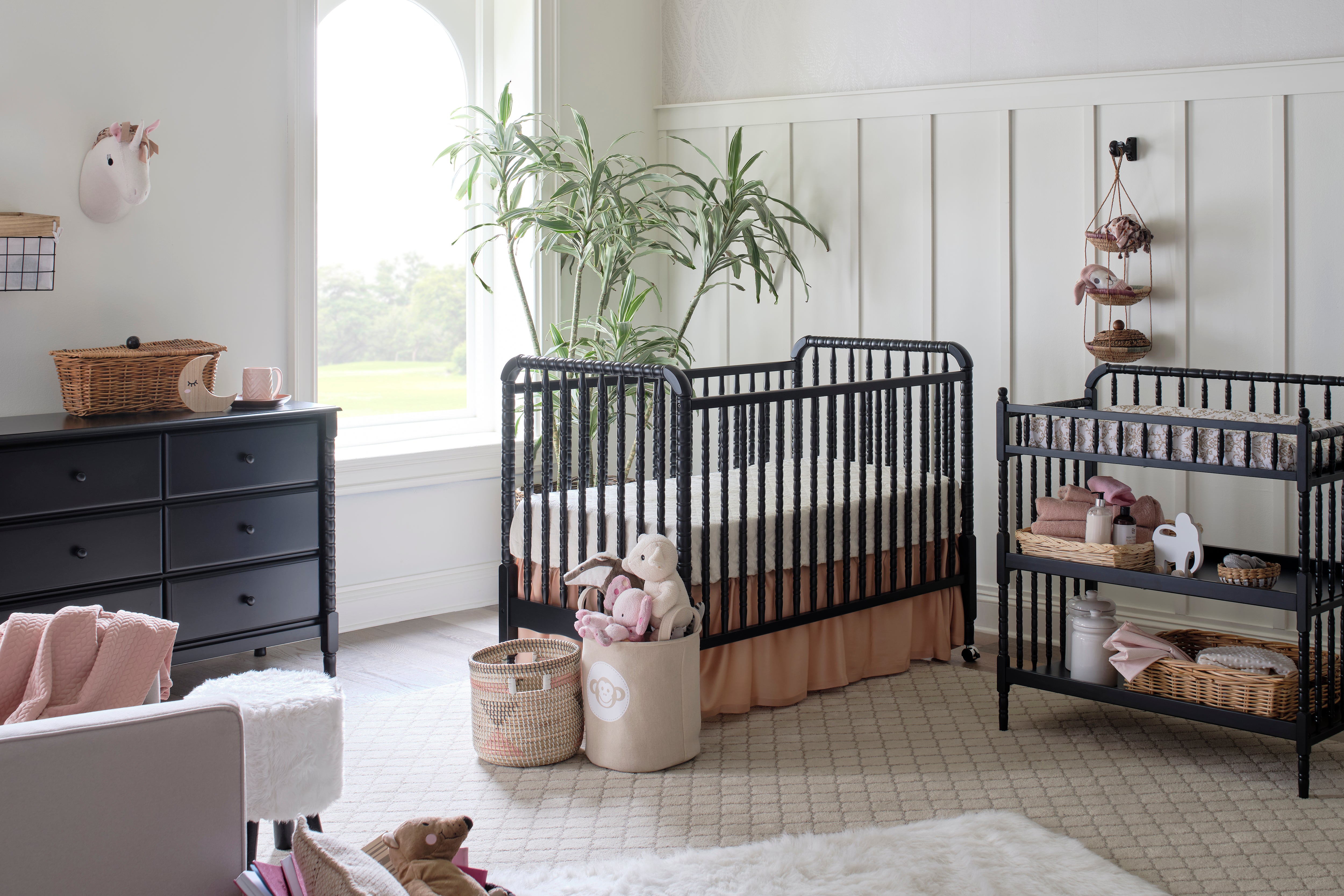 DaVinci Jenny Lind Crib, Changing Table, and 6-Drawer Dresser in Ebony Finish set against elegant wainscoting 