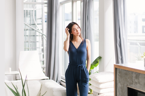 Woman wearing Lav & Kush Romper Looking out of Window