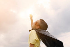 young boy with cape