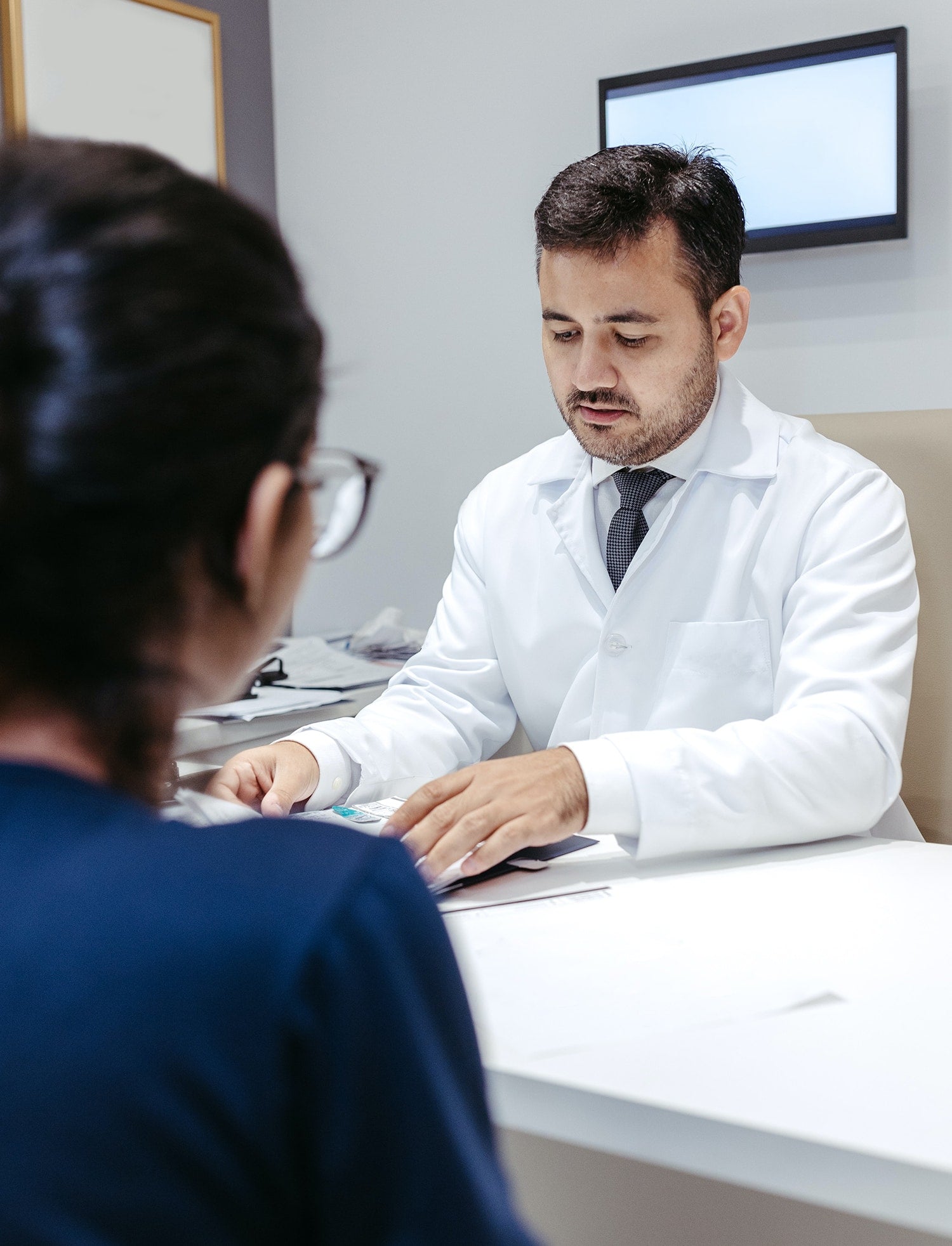 A doctor is talking to a patient in an office.