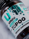 A close-up image of a bottle of zuPOO. Showing the UMZU "U" logo.