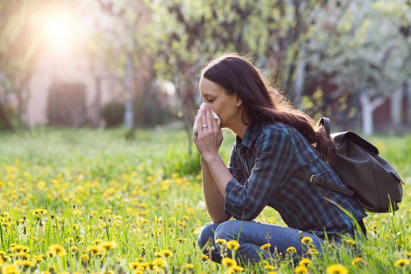 Woman Sneezing in Nature