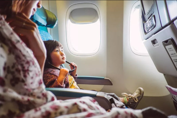 Toddler flying on an airplane