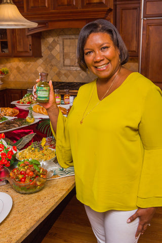 Woman Smiling and Holding Bazodee Hot Sauce